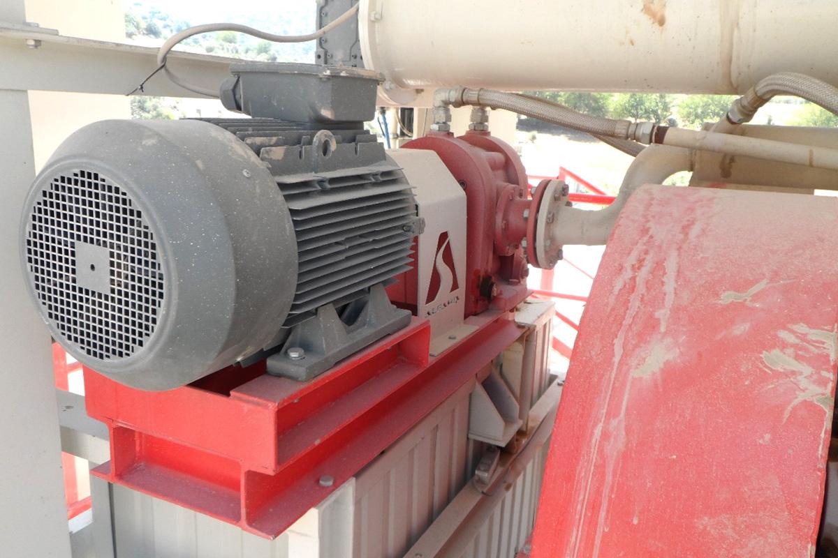 Motor-driven asphalt bitumen pump mounted on a red support frame