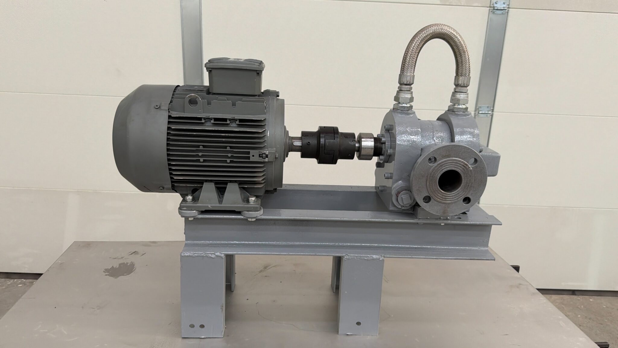 Electric motor-driven bitumen pump set on a gray base frame